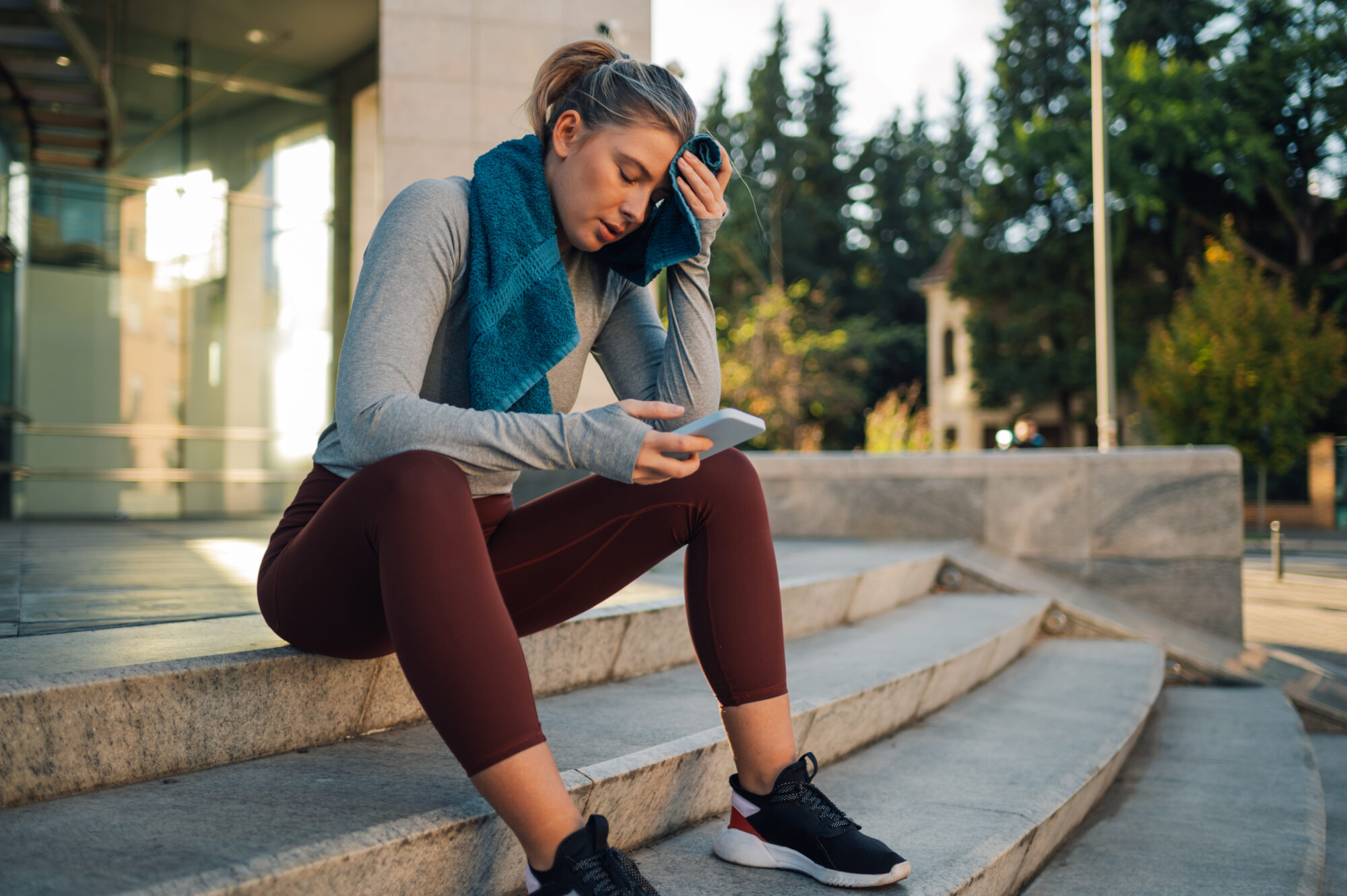 Website maintenance - exhausted woman looking at her phone